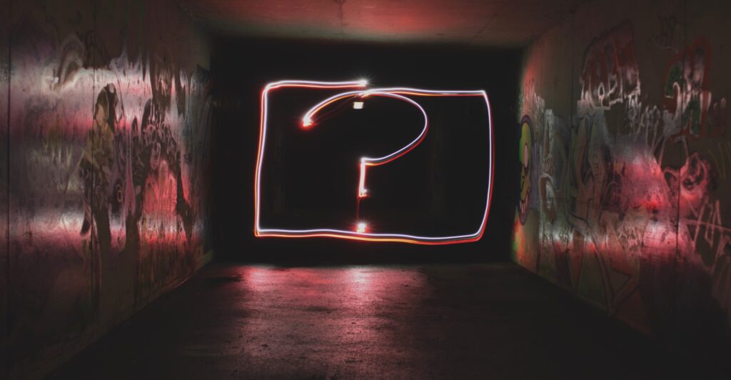 Neon question mark on a black background