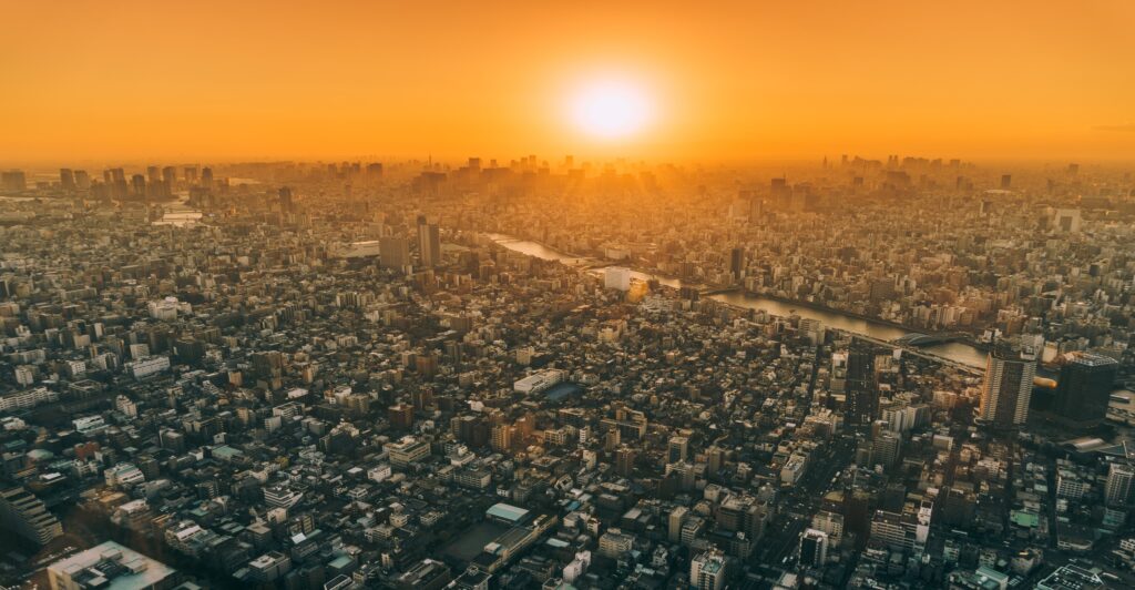Image of sun setting over city landscape seen from above